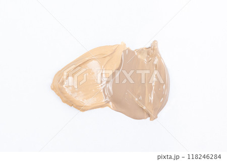 Two strokes of different shades of foundation on a white background. Two strokes of different shades of foundation on a white background. 118246284