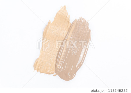 Two strokes of different shades of foundation on a white background. 118246285