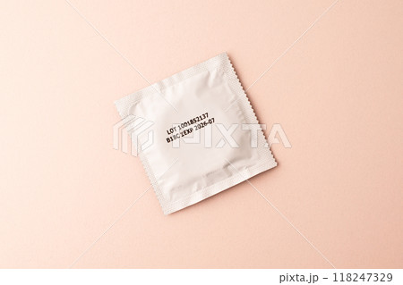Condom on pink colored background. Mens contraception. Sexually transmitted diseases infections protection. Concept of birth control. Safe sex. STD. View from above. High quality photo Condom on pink colored background. Mens contraception. Sexually transmitted diseases infections protection. Concept of birth control. Safe sex. STD. View from above. High quality photo 118247329