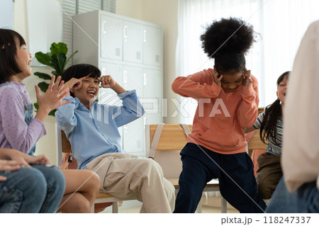Diverse Group of Children Enjoying a Fun Activity with Teacher in Classroom. 118247337