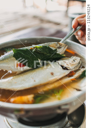 Thai Spicy Mackerel Soup served on wooden table. Thai Spicy Mackerel Soup served on wooden table. 118249224