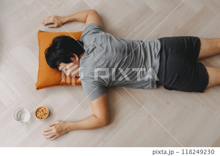 Top view of man sleeping on the floor for a day nap, weekend rest. 118249230