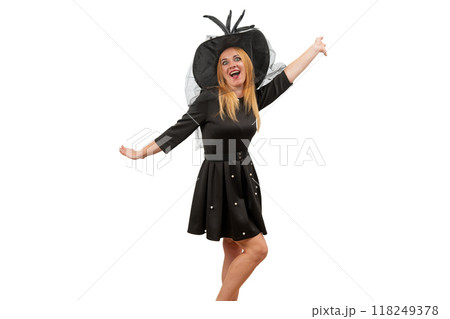 Happy young woman in black witch hat and black dress is dancing. White background. Halloween costume party Happy young woman in black witch hat and black dress is dancing. White background. Halloween costume party 118249378