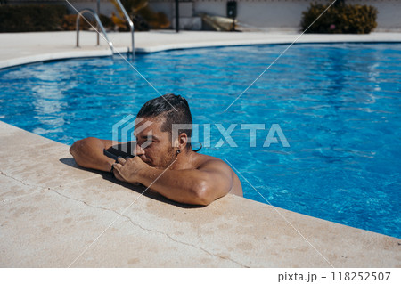 Young man relaxing in swimming pool 118252507