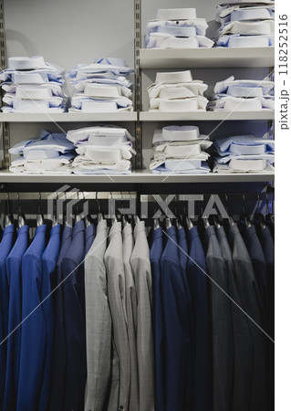 View of shelves and racks of shirts and wedding suits for grooms View of shelves and racks of shirts and wedding suits for grooms 118252516