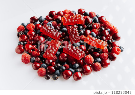 Natural berry marmalade on fresh fruit and berries, perfect for advertising healthy sweet treats Natural berry marmalade on fresh fruit and berries, perfect for advertising healthy sweet treats 118253045