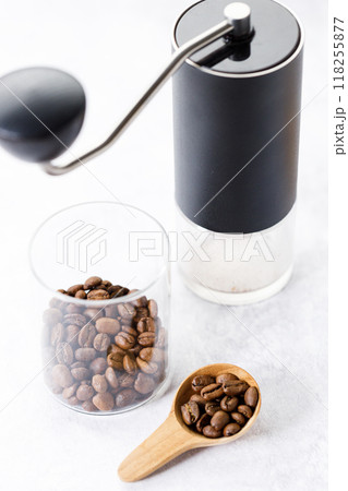Aromatic flavorful Roasted Specialty Coffee Beans with grinder on white Background 118255877