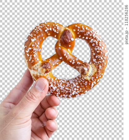A hand holding a freshly baked German pretzel with coarse salt isolated on a transparent background. A hand holding a freshly baked German pretzel with coarse salt isolated on a transparent background. 118256286