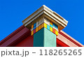 Colorful Architectural Column Against Clear Blue Sky with Geometric Patterns and Contrasting Colors 118265265