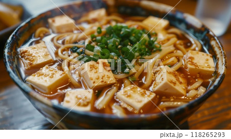 Japanese miso udon noodle with tofu in bowl on wooden table Japanese miso udon noodle with tofu in bowl on wooden table 118265293