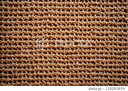 Closeup of cozy beige knit texture, representing warmth, fashion, and handmade craftsmanship 118265654