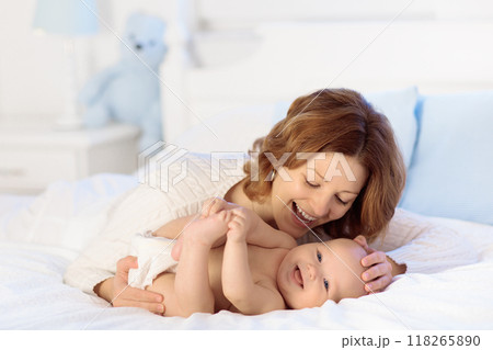 Mother and baby on a white bed Mother and baby on a white bed 118265890