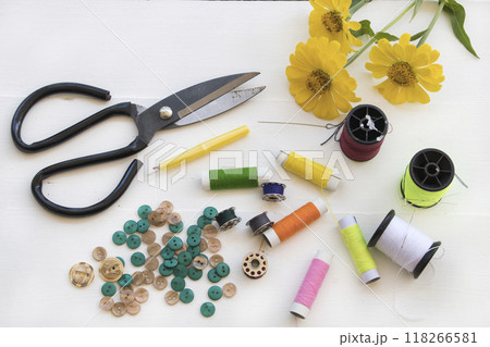 scissors, thread, button for sewing of lifestyle arrangement flat lay style 118266581