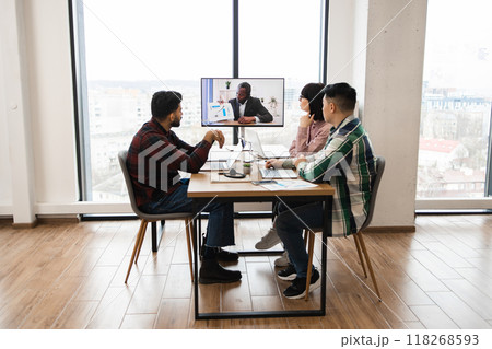 Group of coworkers in video conference meeting at modern office 118268593
