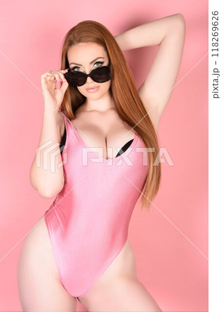 Attractive young woman in a swimsuit and sunglasses 118269626