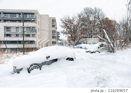 Poland, Krakow, 12.03.2023, snowfall, snowy street with cars after a blizzard 118269657