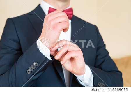 Man Adjusting Cufflinks in a Tuxedo While Preparing for a Formal Event. Man Adjusting Cufflinks in a Tuxedo While Preparing for a Formal Event. 118269675