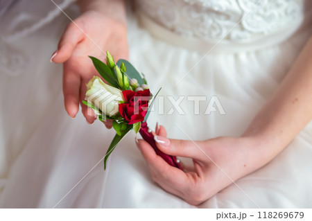 Bride With a Lovely Red and White Boutonniere During Spring Wedding Prep. 118269679