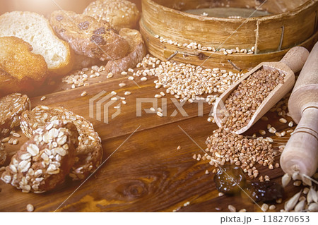 Assortment of baked bread on wooden table background 118270653