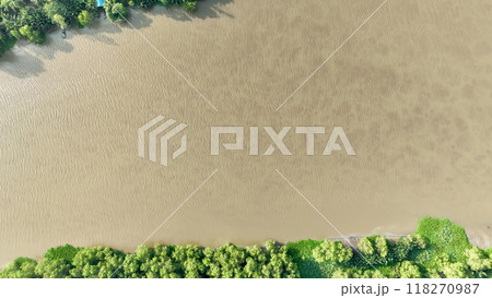 From high above, a bird's eye view reveals the shimmering surface of the Bang Pakong River, winding its way through the landscape. 118270987