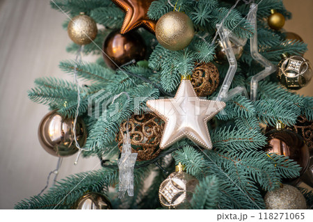 Close up of golden and red balls on christmas tree. Bokeh garlands in the background. New Year concept. 118271065