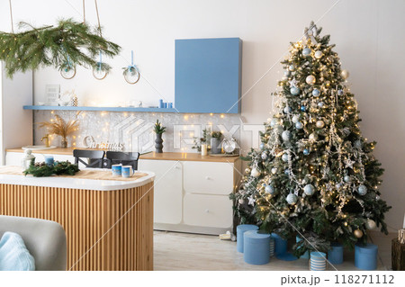 Interior light grey kitchen and red christmas decor. Preparing lunch at home on the kitchen concept. Focus on tree Interior light grey kitchen and red christmas decor. Preparing lunch at home on the kitchen concept. Focus on tree 118271112