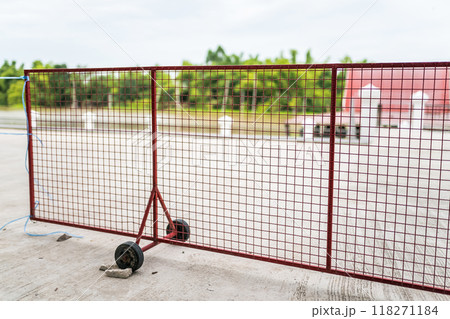 The mobile wheels on the red iron fence allow for easy movement. The mobile wheels on the red iron fence allow for easy movement. 118271184