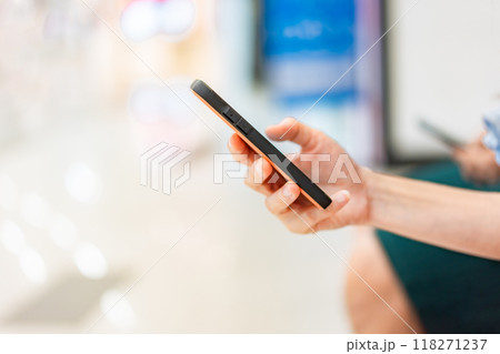 Portrait of hand holding mobile phones. Person is playing and touch screen telephone. Telephone is a modern communication technology. 118271237