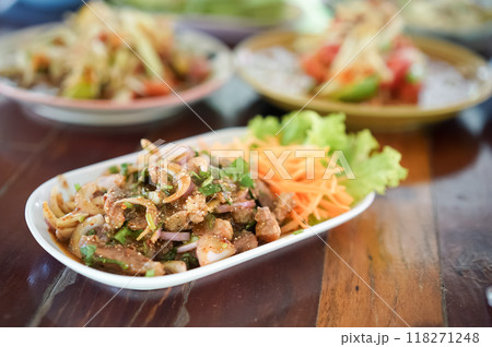 Thai Grilled Pork Neck with Spicy Dipping Sauce. Spicy grilled pork neck salad served with fresh vegetable on wooden table ready to eat. Thai Grilled Pork Neck with Spicy Dipping Sauce. Spicy grilled pork neck salad served with fresh vegetable on wooden table ready to eat. 118271248