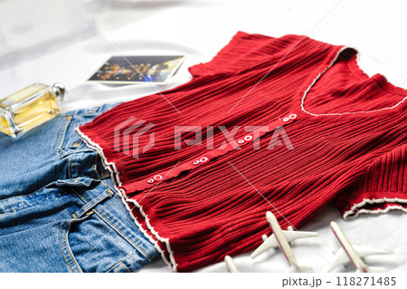 Red shirt blue jean perfume mini airplane toy and postcard isolated on white background top view. Red shirt blue jean perfume mini airplane toy and postcard isolated on white background top view. 118271485