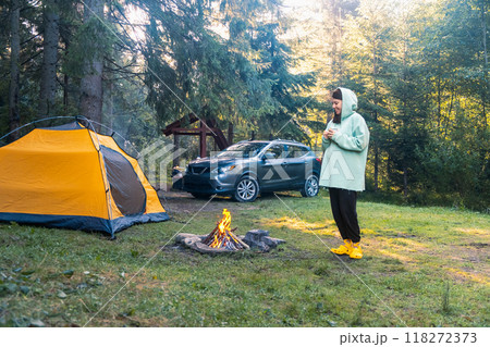 Camping by the Fire in a Serene Forest 118272373