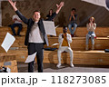 Cheerful lecturer man in formal wear threw up papers and documents 118273085