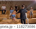 Rear view On Man In Formal Wear Raising Hands Up Celebrating The End Of Lecture Lesson 118273086