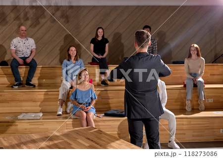 Rear view On Man In Formal Wear Raising Hands Up Celebrating The End Of Lecture Lesson 118273086