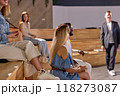 Side view focus on woman sitting on lecture hall listening to speaker man 118273087