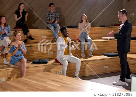 Side view On group of people congratulating celebrating, clapping hands during conference 118273089