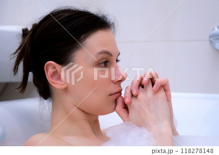 Portrait of sad depressed frustrated woman lying in bathroom after hard day. 118278148