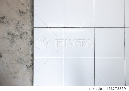Tile floor under construction in room. 118278259