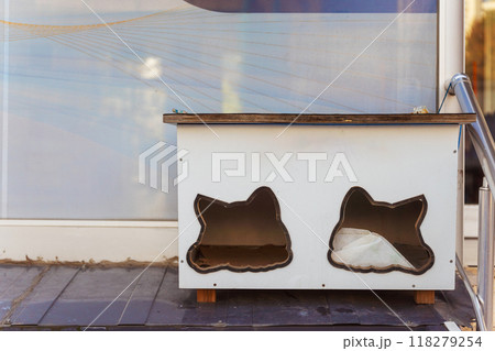 A cat house that has two holes in it seems to resemble a cats head A cat house that has two holes in it seems to resemble a cats head 118279254