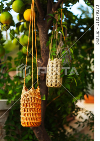 garden lantern wicker made of ropes and glass jar suspended in the garden garden lantern wicker made of ropes and glass jar suspended in the garden 118279273