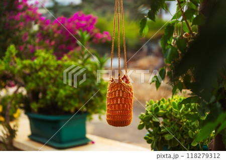 garden lantern wicker made of ropes and glass jar suspended in the garden garden lantern wicker made of ropes and glass jar suspended in the garden 118279312