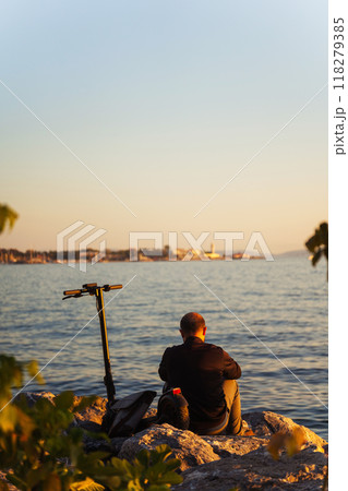 A man with a scooter on the Marmara Sea embankment in Istanbul A man with a scooter on the Marmara Sea embankment in Istanbul 118279385
