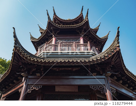 Traditional Chinese pagoda viewed from below under a clear blue sky in a serene park setting Traditional Chinese pagoda viewed from below under a clear blue sky in a serene park setting 118279444