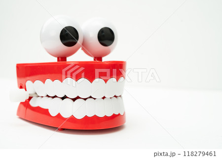 Tooth funny toy denture red color jaw and eye on white background with copy space. Tooth funny toy denture red color jaw and eye on white background with copy space. 118279461