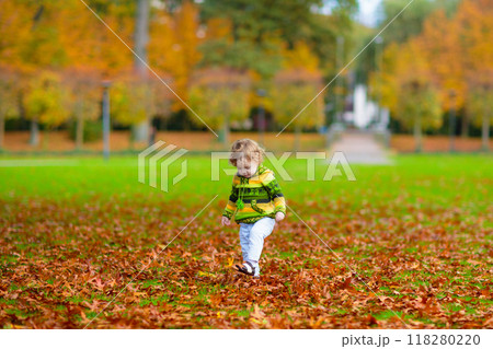 Kids playing in autumn park Kids playing in autumn park 118280220