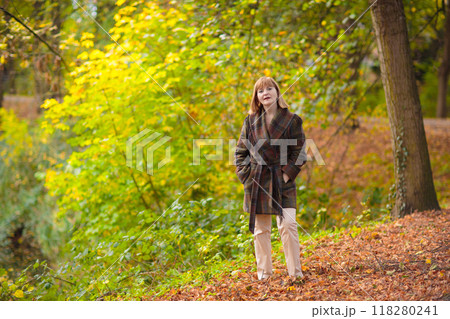 Beautiful woman in autumn park Beautiful woman in autumn park 118280241