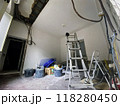 Renovation room with ladder and exposed electrical wires 118280450