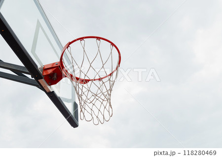Basketball backboard hoop white net on sports court at courtyard. Outdoors. Summer game. Close up. Copy space. Basketball backboard hoop white net on sports court at courtyard. Outdoors. Summer game. Close up. Copy space. 118280469