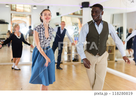 Woman with african man practising charleston dancing 118280819