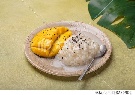 Sweet mango with sticky rice and sesame seeds being served on a plate. Traditional dessert of Thailand 118280909